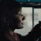 interior shot of an older Black woman behind the wheel of a teal 1957 chevrolet nomad